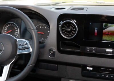 Black interior dashboard closeup of Mercedes-Benz specialty vehicle.