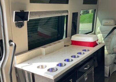 Interior of indulger specialty vehicle showing kitchenette setup.