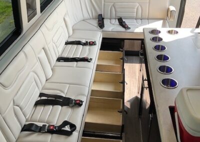 Interior of indulger specialty vehicle showing storage space underneath bench seating.