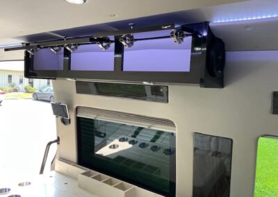 Interior of indulger specialty vehicle showing upper cabinets with interior lights.