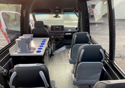 Interior of Pano specialty vehicle with beverage center on left. 2 Keurigs on counter.