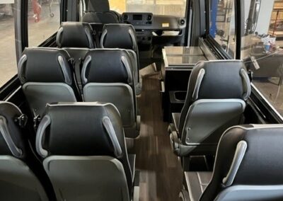 Interior of specialty vehicle with 9 seats and beverage center.