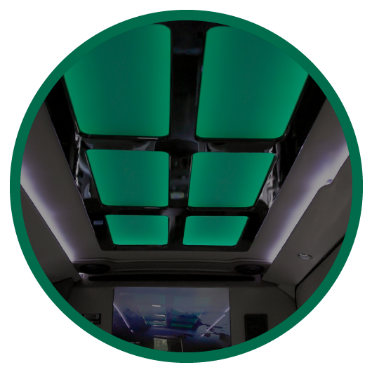 Round image of green lights on interior roof of specialty vehicle.