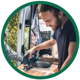 Round image of man holding tool building specialty vehicle.