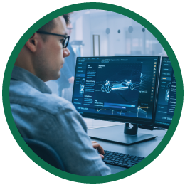 Round image with green outside circle of man working on computer.