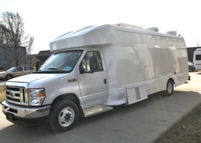 Exterior of white mobile cooking unit.