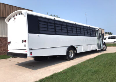 Large white prisoner bus exterior.