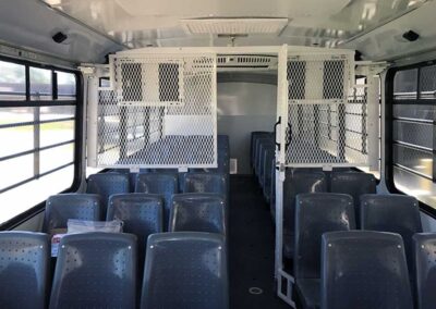 Interior of prisoner bus front to rear view.