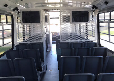 Interior of prisoner bus rear to front view.