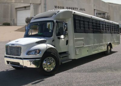 Large white prisoner transport specialty bus