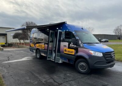 Exterior image of Bookmobile specialty vehicle with awning pulled down on side.