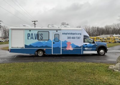 Outside of P.A.W.S mobile pet services vehicle