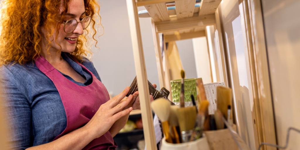 woman looking through paint brushes