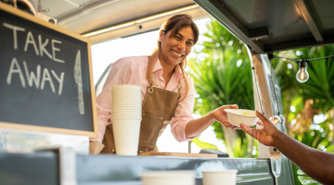 Cheerful young female in casual clothes smiling after pursuing her mobile business ideas