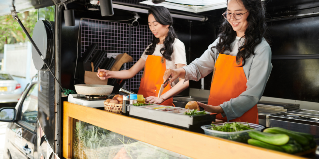 two woman in a mobile food truck